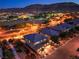 Night aerial view of homes with city lights and mountain views at 10243 Aragon Crown Rd, Las Vegas, NV 89135