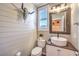 Charming powder room featuring shiplap walls, unique mirror, and modern sink at 10243 Aragon Crown Rd, Las Vegas, NV 89135