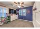 Spacious bedroom featuring ceiling fan, shuttered windows, large dresser, and fun superhero decor at 10243 Aragon Crown Rd, Las Vegas, NV 89135