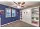 Well-decorated bedroom with superhero decor, ceiling fan, shuttered windows, and ample storage at 10243 Aragon Crown Rd, Las Vegas, NV 89135