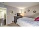 Cozy bedroom features neutral decor, TV, and sunburst mirrors creating a comfortable and inviting space at 10243 Aragon Crown Rd, Las Vegas, NV 89135