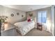 Cozy bedroom with white bedding, neutral walls, shuttered windows, and accent decor at 10243 Aragon Crown Rd, Las Vegas, NV 89135