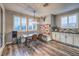 Charming dining area with shuttered windows, modern light fixture, built-in bench seating, and rustic decor at 10243 Aragon Crown Rd, Las Vegas, NV 89135