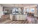 Gourmet kitchen boasts granite counters, stainless appliances, large island with a dishwasher, and open to living and dining spaces at 10243 Aragon Crown Rd, Las Vegas, NV 89135