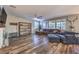 Spacious living room with hardwood floors, a large sectional sofa, and ample natural light at 10243 Aragon Crown Rd, Las Vegas, NV 89135