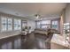 Spacious main bedroom with dark wood floors, ceiling fan, sitting area, and vanity at 10243 Aragon Crown Rd, Las Vegas, NV 89135