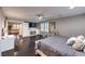 Large main bedroom features a ceiling fan, TV, ensuite bathroom, and sitting area at 10243 Aragon Crown Rd, Las Vegas, NV 89135