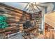 Cozy office with rustic wood accent wall, modern desk, and ample natural light from shuttered windows at 10243 Aragon Crown Rd, Las Vegas, NV 89135