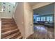 Staircase leads to living area with comfortable sofas and shuttered windows at 10243 Aragon Crown Rd, Las Vegas, NV 89135