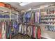 Spacious walk-in closet filled with neatly organized clothing and shoes on shelves and racks at 10243 Aragon Crown Rd, Las Vegas, NV 89135