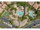 Aerial view showcasing community pool, playground, and lounge areas surrounded by lush landscaping and ample parking at 10300 S Dapple Gray Rd, Las Vegas, NV 89178
