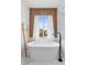 Modern bathroom features a freestanding tub, wood accent wall, and marble floors at 10300 S Dapple Gray Rd, Las Vegas, NV 89178