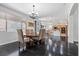 Elegant dining room featuring a modern chandelier and hardwood flooring at 10300 S Dapple Gray Rd, Las Vegas, NV 89178