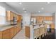 Well-lit kitchen featuring stainless steel appliances, wooden cabinetry, and a breakfast bar with seating at 10300 S Dapple Gray Rd, Las Vegas, NV 89178