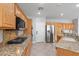Updated kitchen with granite counters, stainless appliances and wood cabinetry at 10300 S Dapple Gray Rd, Las Vegas, NV 89178