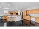 Spacious kitchen with wood cabinets, granite countertops, stainless appliances, and dark wood floors at 10300 S Dapple Gray Rd, Las Vegas, NV 89178
