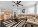 Bright living room featuring hardwood floors, ceiling fan, and comfortable seating area at 10300 S Dapple Gray Rd, Las Vegas, NV 89178