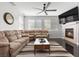 Bright and airy living room featuring a cozy fireplace, comfortable sofas, and a large television at 10300 S Dapple Gray Rd, Las Vegas, NV 89178