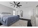 Spacious main bedroom with dark wood floors, ceiling fan, and ensuite bathroom at 10300 S Dapple Gray Rd, Las Vegas, NV 89178