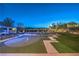 Backyard with putting green and pool features lounge seating, outdoor kitchen, and gazebo at 10319 Larkmead Ave, Las Vegas, NV 89149