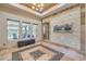 Bright living area with stone accent wall, fountain feature, neutral decor, and outdoor views at 10319 Larkmead Ave, Las Vegas, NV 89149