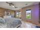 Beautiful main bedroom with stone accent wall, decorative dresser, and backyard view at 10319 Larkmead Ave, Las Vegas, NV 89149
