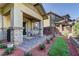 Cozy covered back patio with brick columns, stone pavers, and a small patch of lawn at 10360 Pescado Ln, Las Vegas, NV 89135