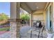 Enjoy the outdoor space on the cozy covered back patio with brick columns and stone pavers at 10360 Pescado Ln, Las Vegas, NV 89135