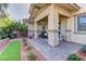 Paver patio with stone columns offers outdoor seating and a lush lawn for relaxing or entertaining at 10360 Pescado Ln, Las Vegas, NV 89135