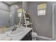 Bathroom featuring a vanity, commode, decorative ladder display and natural light at 10360 Pescado Ln, Las Vegas, NV 89135
