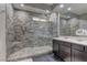 Bathroom featuring a glass enclosed walk-in shower with designer tile and a marble vanity at 10360 Pescado Ln, Las Vegas, NV 89135