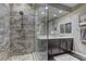 Bathroom featuring a glass enclosed walk-in shower with designer tile and a marble vanity at 10360 Pescado Ln, Las Vegas, NV 89135