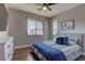 Comfortable bedroom with hardwood floors, a ceiling fan, and plenty of natural light at 10360 Pescado Ln, Las Vegas, NV 89135
