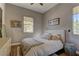 Cozy bedroom with natural light, decorative artwork, and comfortable bedding at 10360 Pescado Ln, Las Vegas, NV 89135