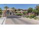 Entry gate into the community, featuring beautiful brick paving and mature landscaping at 10360 Pescado Ln, Las Vegas, NV 89135