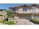 Charming two-story home boasts a two-car garage, brick driveway, and well-maintained landscaping at 10360 Pescado Ln, Las Vegas, NV 89135