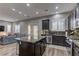 Spacious kitchen with stainless steel appliances, granite countertops, an island, and seamless flow to the living area at 10360 Pescado Ln, Las Vegas, NV 89135