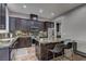 Modern kitchen boasts dark cabinets, granite countertops, a center island, and stainless steel appliances at 10360 Pescado Ln, Las Vegas, NV 89135