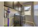Efficient laundry room with overhead cabinets, window, and full size washer and dryer at 10360 Pescado Ln, Las Vegas, NV 89135