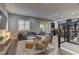 Spacious living room features a plush sectional sofa, wooden floors, and natural light from the large window at 10360 Pescado Ln, Las Vegas, NV 89135