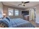 Bedroom with picture windows, ceiling fan, and ensuite bathroom entrance at 10360 Pescado Ln, Las Vegas, NV 89135