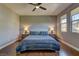 Bedroom with picture windows, ceiling fan, and matching bedside tables at 10360 Pescado Ln, Las Vegas, NV 89135