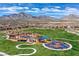 Aerial view of a colorful community park and playground surrounded by homes and mountain views at 1064 Calvia St, Las Vegas, NV 89138