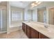 This bathroom offers a double sink vanity, a shower and a tub at 1064 Calvia St, Las Vegas, NV 89138