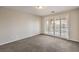 A spacious bedroom with balcony access and carpet at 1064 Calvia St, Las Vegas, NV 89138