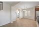Neutral dining room features tile floors, view to the laundry room and light fixtures at 1064 Calvia St, Las Vegas, NV 89138