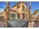 Two-story home with a balcony, covered patio, and manicured landscaping in the backyard at 1064 Calvia St, Las Vegas, NV 89138