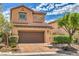 Charming two-story home with a brown tiled roof, two-car garage and desert landscaping at 1064 Calvia St, Las Vegas, NV 89138