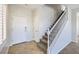 Bright foyer with tile flooring, stairs with white railing, and a white front door at 1064 Calvia St, Las Vegas, NV 89138