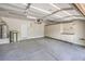 Spacious garage featuring epoxy floors, ample storage cabinets, and a water heater at 1064 Calvia St, Las Vegas, NV 89138